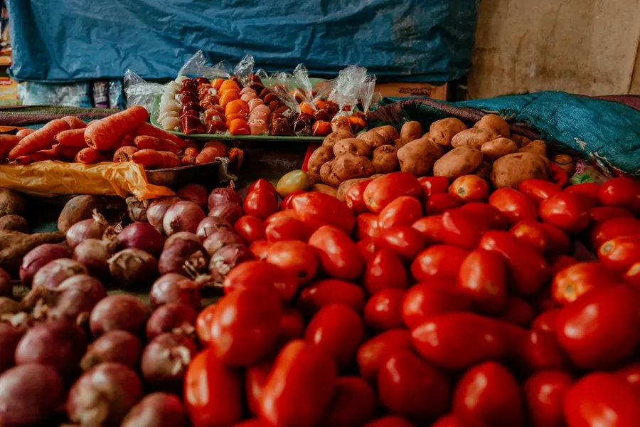 Onions, tomatoes and potatoes at a vegetable market